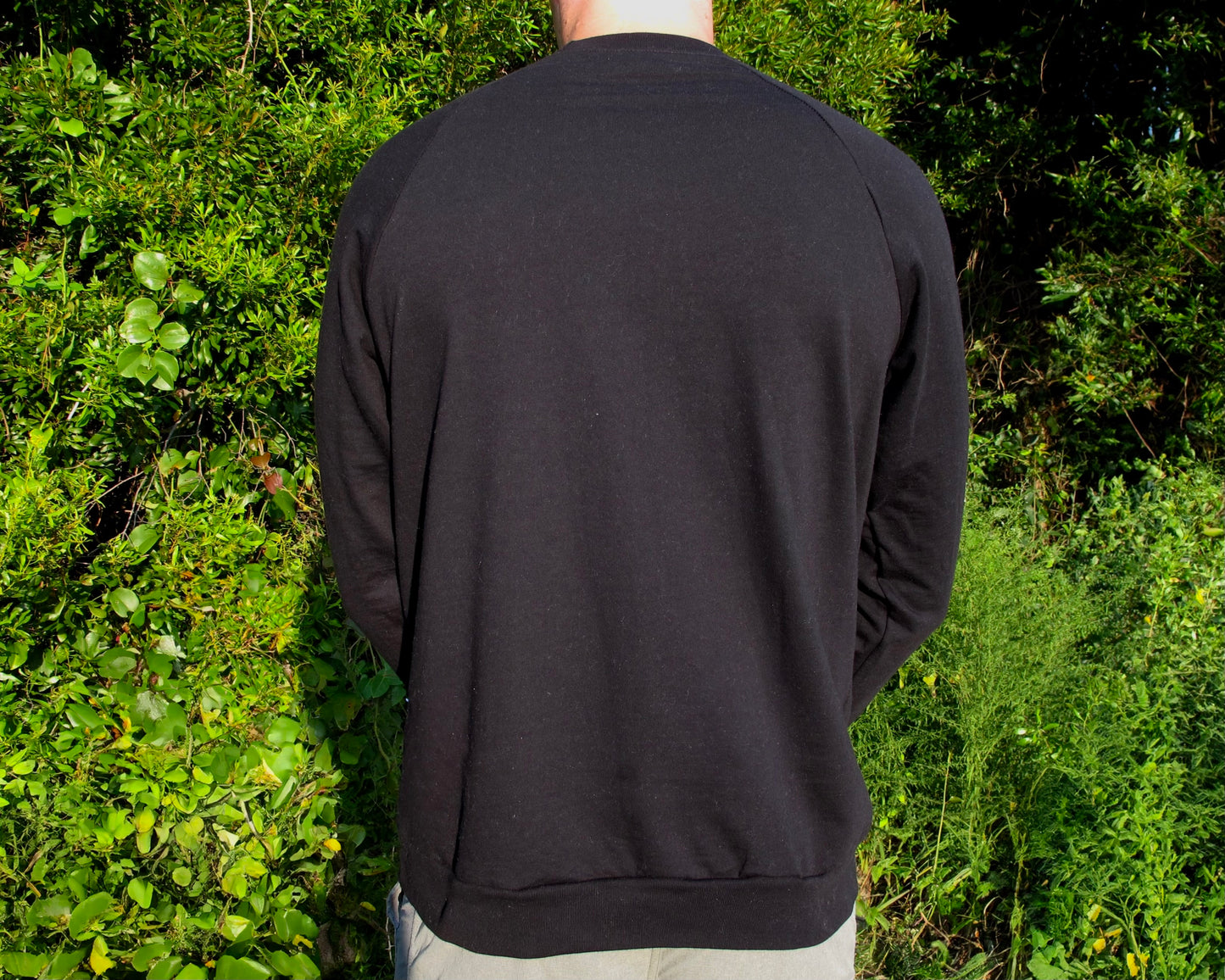 Unisex black crewneck sweater by Breath, designed for all-day comfort. Made in the USA with 100% organic cotton, combining style and eco-friendly design.