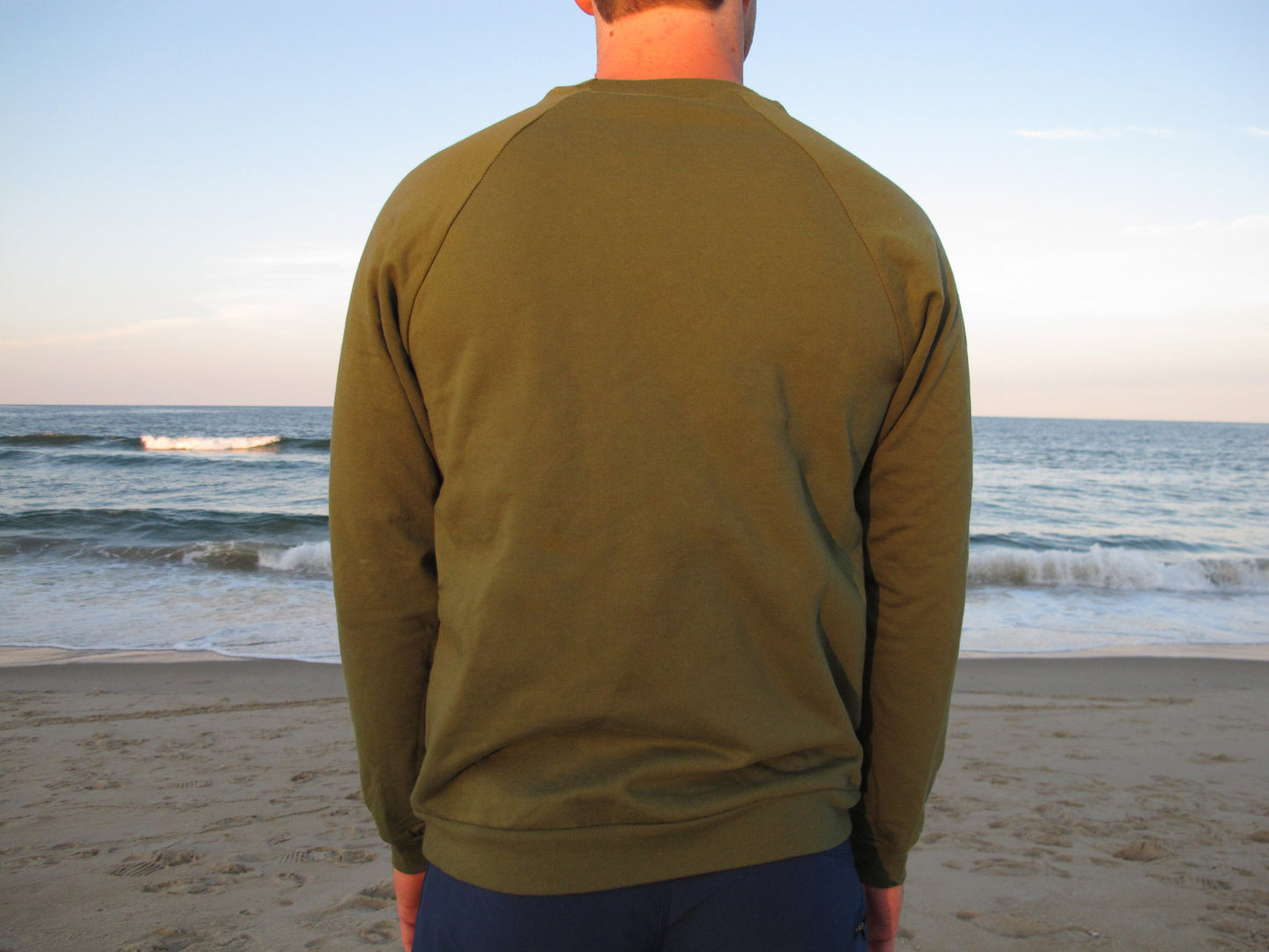 Unisex green crewneck sweater by Breath, designed for comfort and style. Made in the USA with 100% organic cotton for a sustainable look.