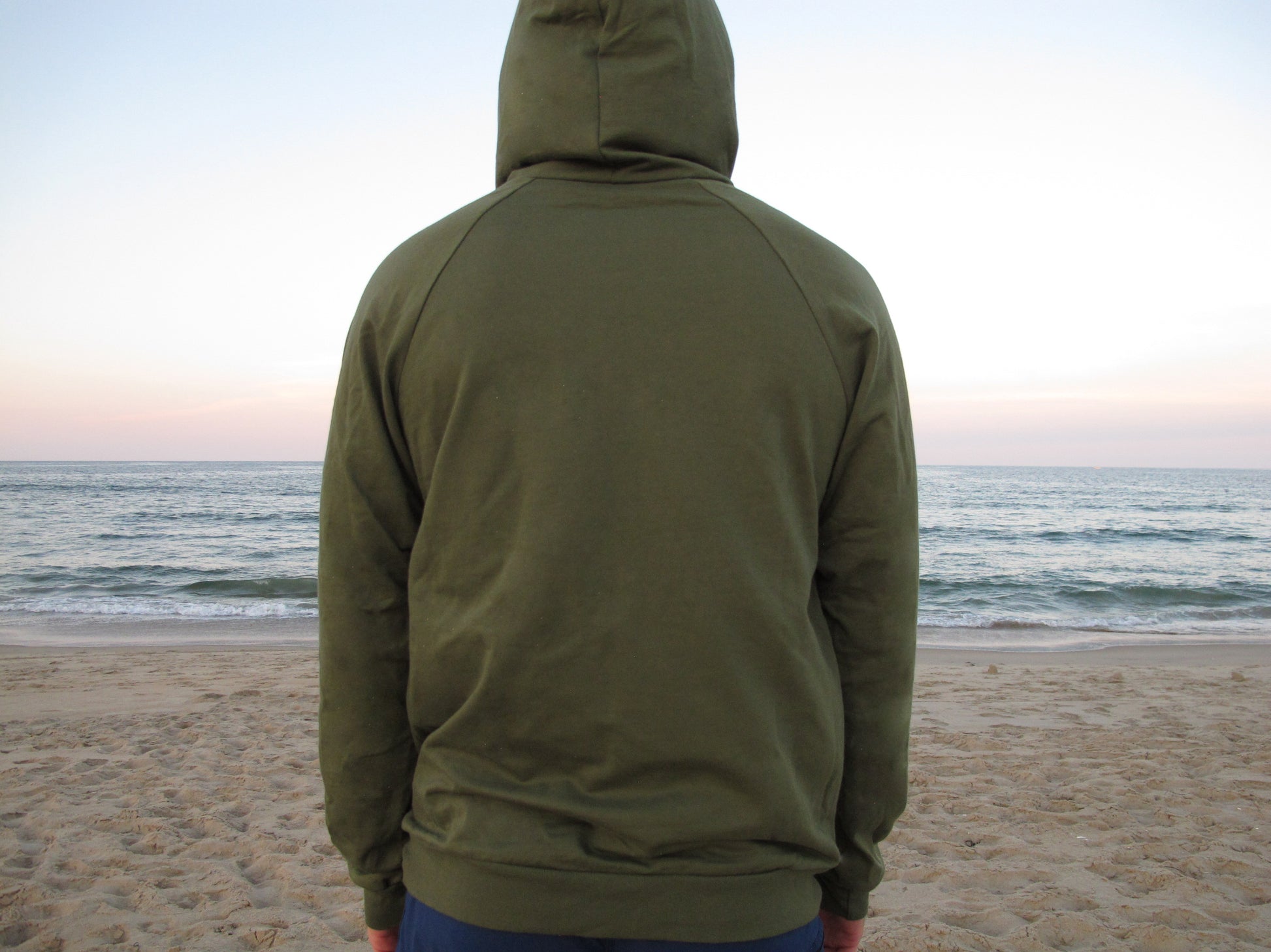 Unisex green hoodie by Breath, ethically made in the USA from 100% organic cotton. Soft, sustainable, and designed for all-day comfort.