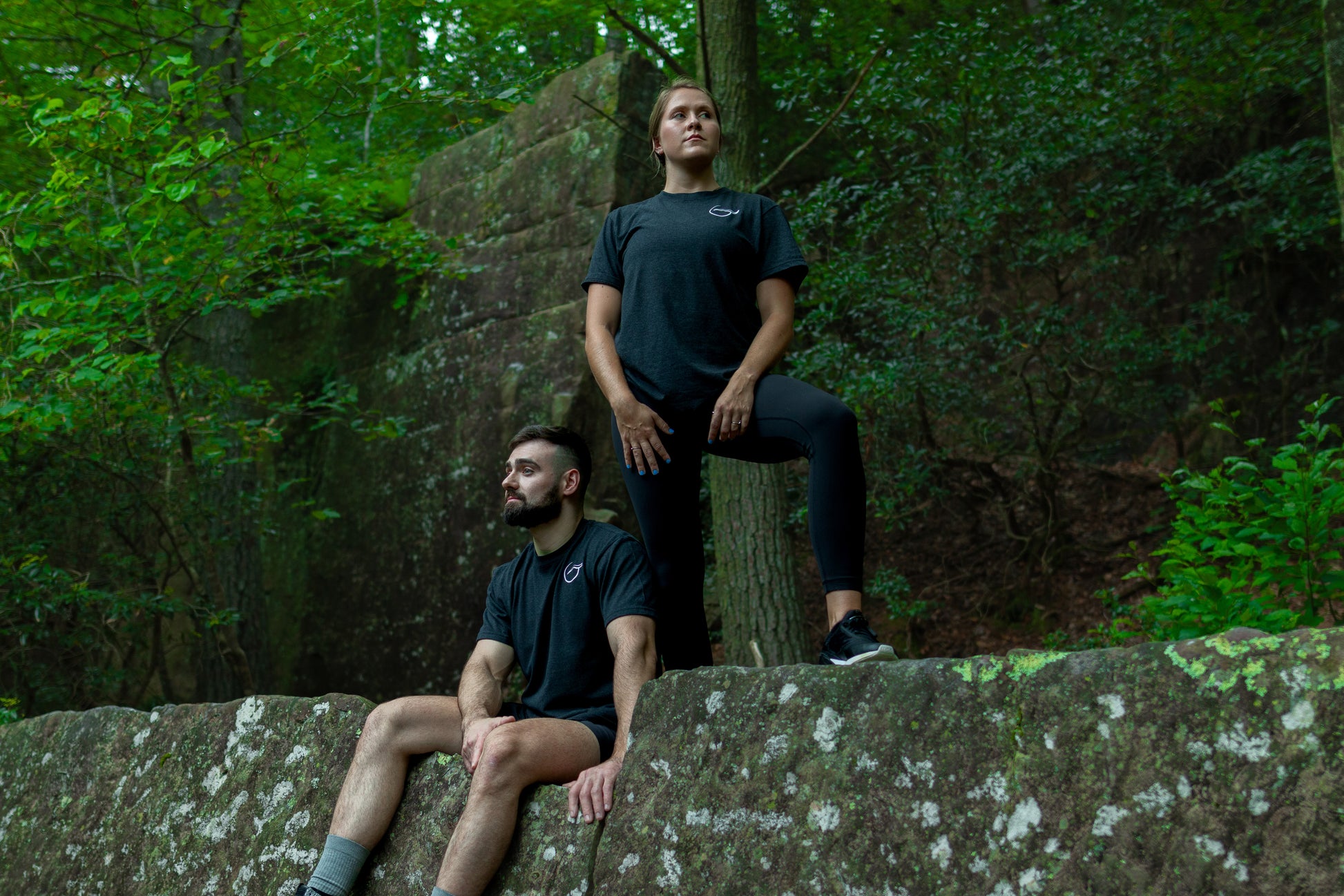 Duo wearing the Black Balance 50 50 Up-Cycled Cotton and Recycled Polyester Short Sleeve T shirt With the Breath Logo on the Left Chest and Breath across the Back.