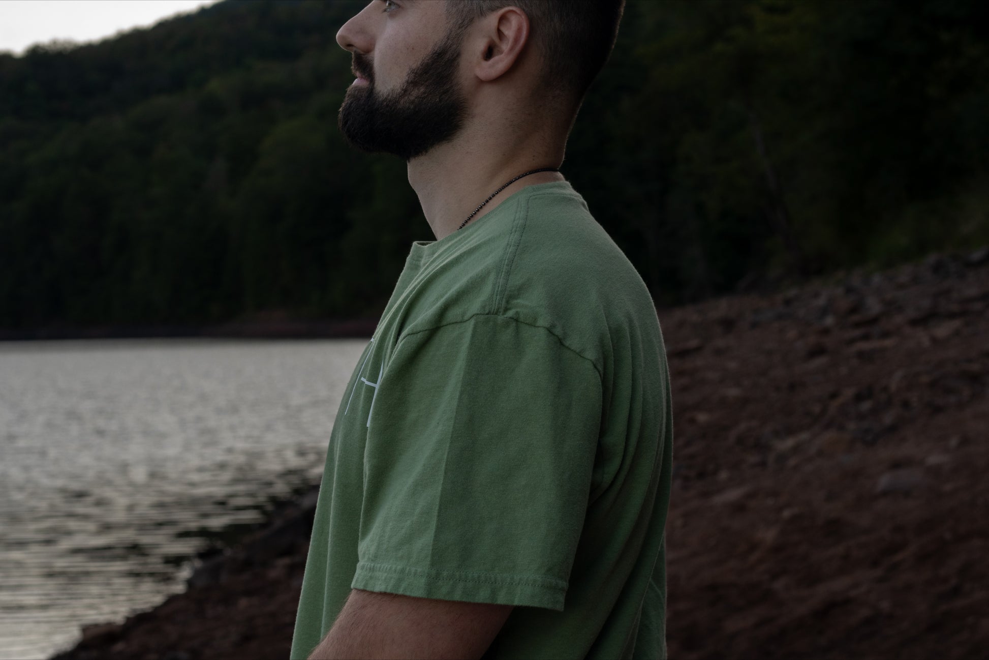 Side view of 100% organic cotton light mint green t-shirt with logo on the back and Breath across the front.